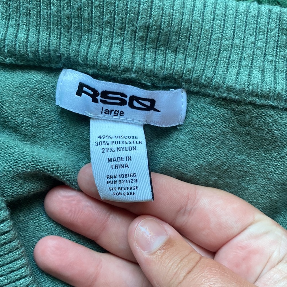 This is a mini light sage green and white button up with long sleeves.